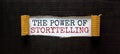 The words `the power of storytelling` appearing behind torn black paper. Beautiful background. Business concept