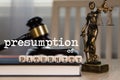 Words PRESUMPTION of PATERNITY  composed of wooden dices. Wooden gavel and statue of Themis in the background Royalty Free Stock Photo