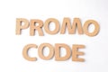 Words Promo Code made of wooden letters on white background, top view