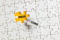 The words pros and cons on the missing puzzle pieces Royalty Free Stock Photo