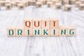 The Words Quit Drinking Formed By Wooden Blocks On A White Table, Reminder Concept