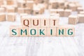 The Words Quit Smoking Formed By Wooden Blocks On A White Table, Reminder Concept