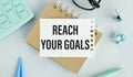 Reach your goals written on a white notebook. Closeup of a personal agenda Royalty Free Stock Photo
