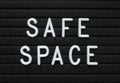 The words Safe Space in white plastic letters on a black letter board