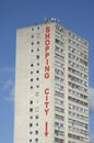 Words shopping city written on high white block of flats on blue