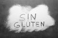 Words Sin gluten written with flour on grey background, top view Royalty Free Stock Photo