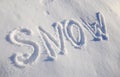 The words SNOW are written in snow. Written word on a snow white field Royalty Free Stock Photo