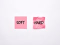 The words soft and hard on pink sheets of note paper. Soft skills and hard skills