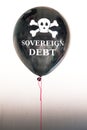 The words sovereign debt in white and a skull and cross bones on a balloon illustrating the concept of a debt bubble