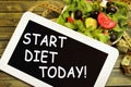 The words Start diet today on tablet