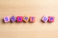 Words START UP made with color cubes on wooden background, flat lay