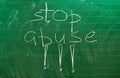 The words STOP ABUSE written on the green school board Royalty Free Stock Photo