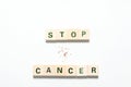 Words stop cancer made of wooden blocks and some tobacco isolated on white background