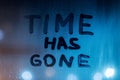 the words time has gone handwritten on night wet window glass surface Royalty Free Stock Photo