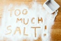 Words TOO MUCH SALT handwritten on salt Royalty Free Stock Photo