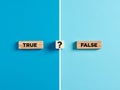 The words true and false on wooden blocks with question mark symbol Royalty Free Stock Photo
