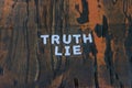 The words truth and lie written in white block letters