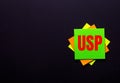 The words USP Unique Selling Proposition on a bright sticker on a dark background. Copy space