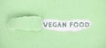 The words vegan food standing on a green ripped up paper Royalty Free Stock Photo