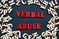 Words verbal abuse and wooden letters around.