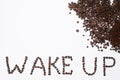 Words wake up from coffee beans isolated on white background