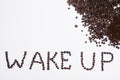 Words wake up from coffee beans isolated on white background