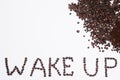 Words wake up from coffee beans isolated on white background