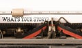 Words WHATS YOUR STORY written on vintage typewriter