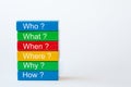 The words: Who, What, When, Where, Why and How are written on colorful blocks