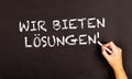Words  Wir Bieten Losungen written on a blackboard Royalty Free Stock Photo