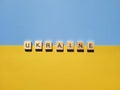Words on wooden alphabet letters on yellow, blue background close up. Flat lay. Concept of Ukraine freedom and support. Royalty Free Stock Photo