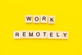 Words work remotely. Wooden blocks with lettering on top of yellow background. Human Resource Management and Recruitment