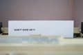 the words & x22;don& x27;t give up& x22; on the printer paper Royalty Free Stock Photo