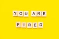 Words You Are Fired. Wooden blocks with lettering on top of yellow background. Human Resource Management and Recruitment Royalty Free Stock Photo