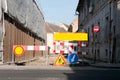 Work ahead street reconstruction site with sign and fence as road barricade