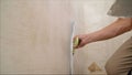 Work aligns with a spatula wall. Worker plastering a wall with a spatula Royalty Free Stock Photo