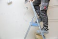 Filling and smoothing walls using gypsum putty.