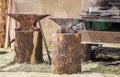 Work area of an ironsmith with scrap metals, anvils and hammer Royalty Free Stock Photo