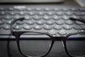 Work area with keyboard and eye glasses Royalty Free Stock Photo