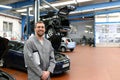 Work in an auto repair shop - portrait of a smiling service man