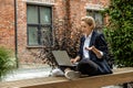 Young business woman sitting in a lotus pose and working on laptop Royalty Free Stock Photo