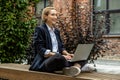 Young business woman sitting in a lotus pose and working on laptop Royalty Free Stock Photo