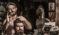 Bearded man in barbershop. Work in the barber shop. Hairdresser cutting hair of male client. Hairstylist serving client Royalty Free Stock Photo