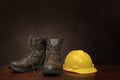 Work Boots and Construction Helmet On Brown With Copy Space