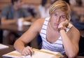 This work is so boring....A bored young student looking at the camera during study period.