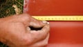 Work on building a house. Stock footage. Man working makes a marking on the slate measuring with a ruler Royalty Free Stock Photo