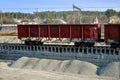 Unloading of crushed stone a railway car of a dump truck, closeup.