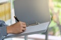 Work and Business Concept. CLoseup of businessman hand writing note on paper clip folder Royalty Free Stock Photo