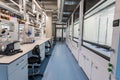 Chemistry lab with white cabinets, chemist workstations and swivel castor chairs. High room. Chemical preparations, test tubes and Royalty Free Stock Photo