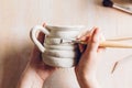 Work on a clay mug in a ceramic workshop. Royalty Free Stock Photo